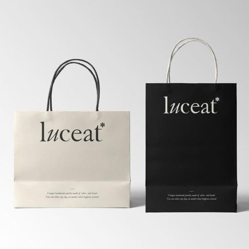 Eco-friendly twisted handle paper bag made from recyclable paper, perfect for retail and gifts.