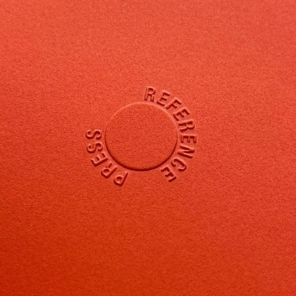 Raised embossed logo detail on luxury packaging.