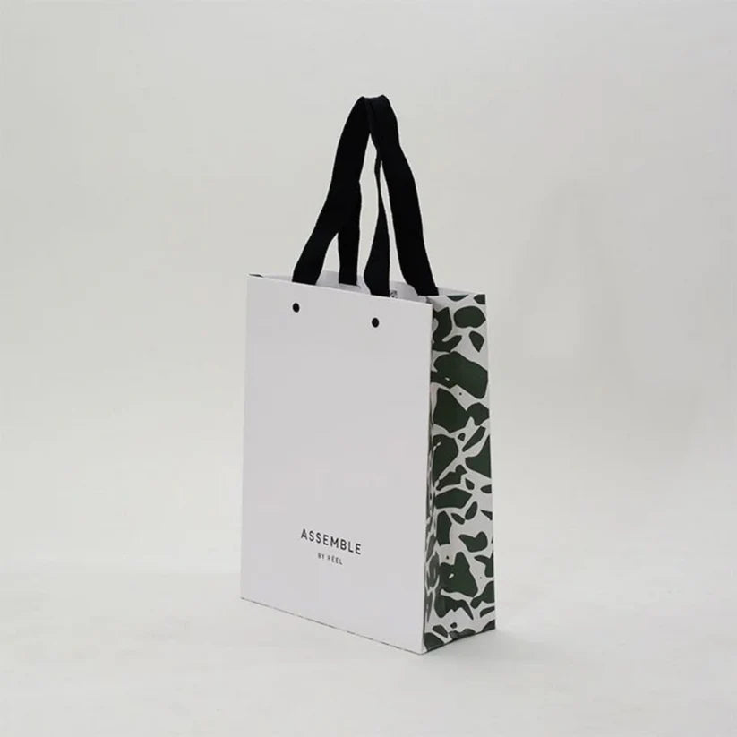 Full-color printed paper bag with reinforced handles for gifts and retail packaging.