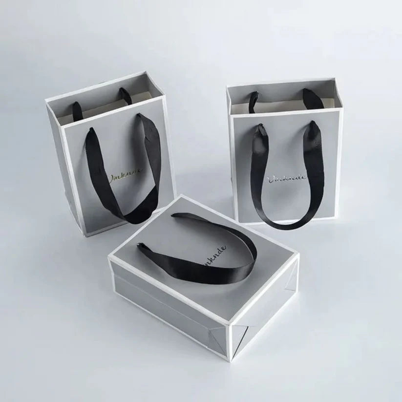 Premium luxury paper bag with foil stamping and reinforced handles for gift packaging.