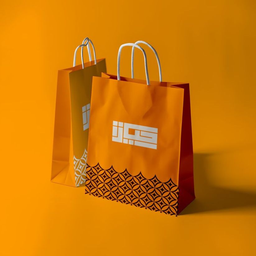 Wholesale twisted handle paper bags with reinforced handles and custom printing for businesses.